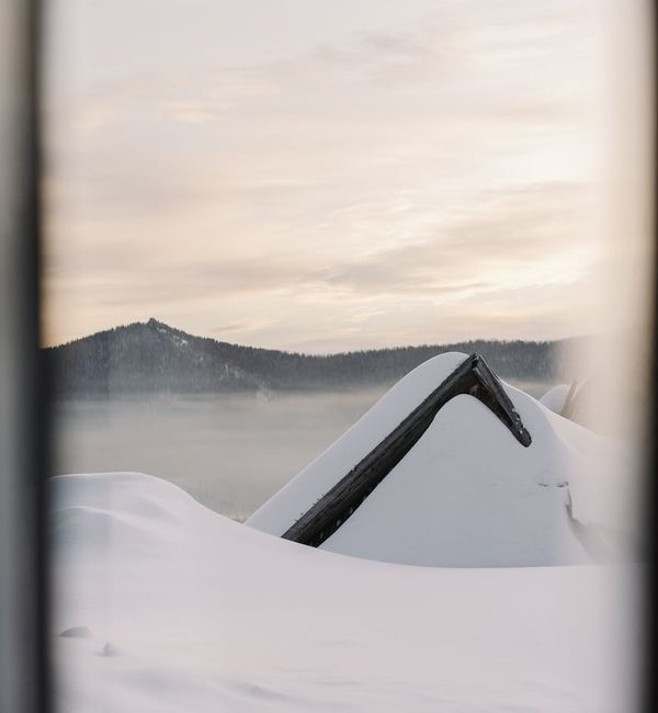 Person meditating outdoors during a beautiful sunrise, feeling peaceful.